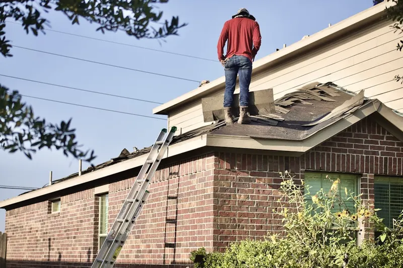 Professional roofer working on a residential roof in Hecla